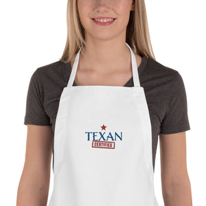 close up of a woman wearing a white apron with Texan Cerfified embroiderd on front offered by mytexasgift.com