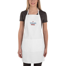 Load image into Gallery viewer, woman wearing a white apron with Texan Cerfified embroiderd on front offered by mytexasgift.com